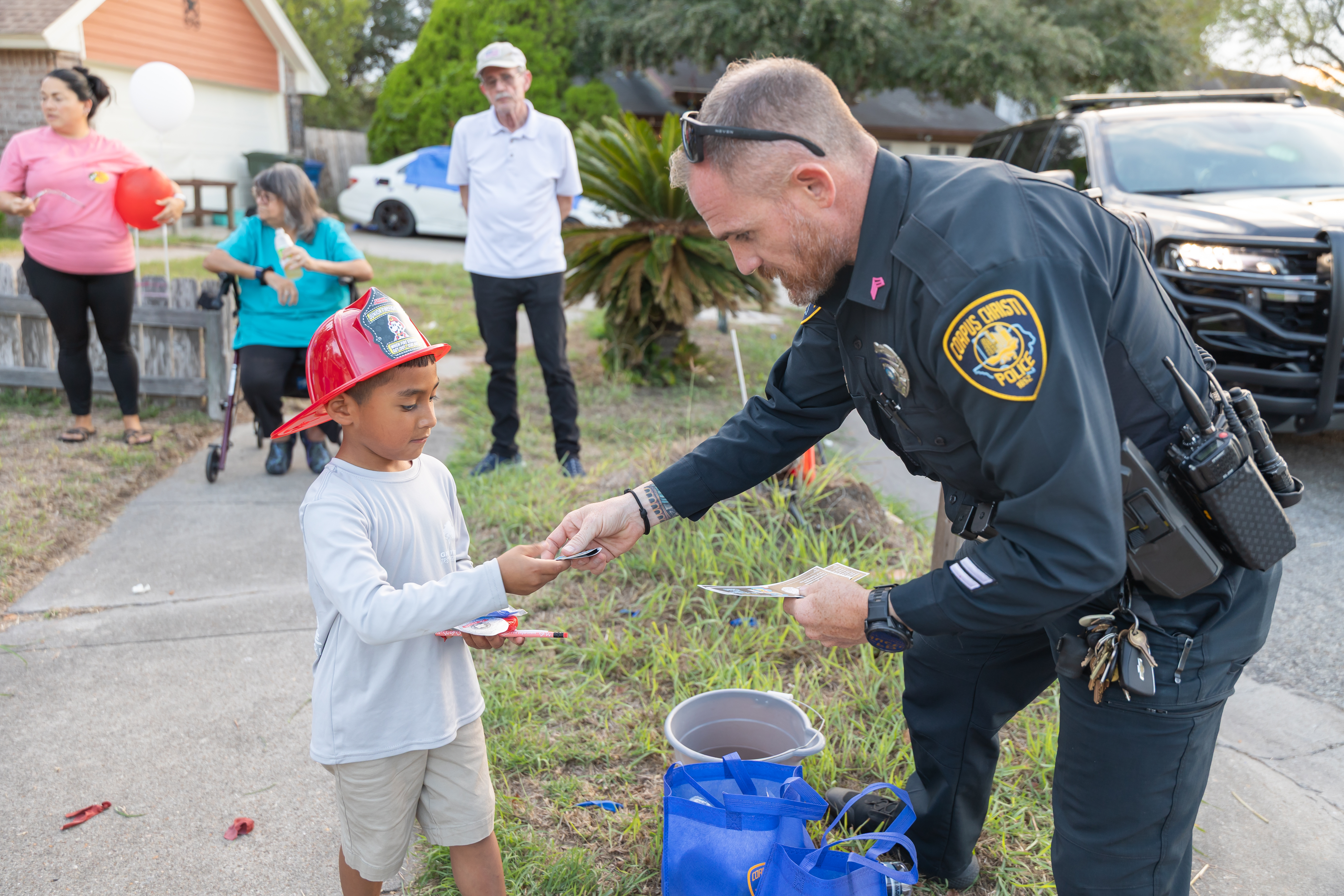 officer handing out candy to child